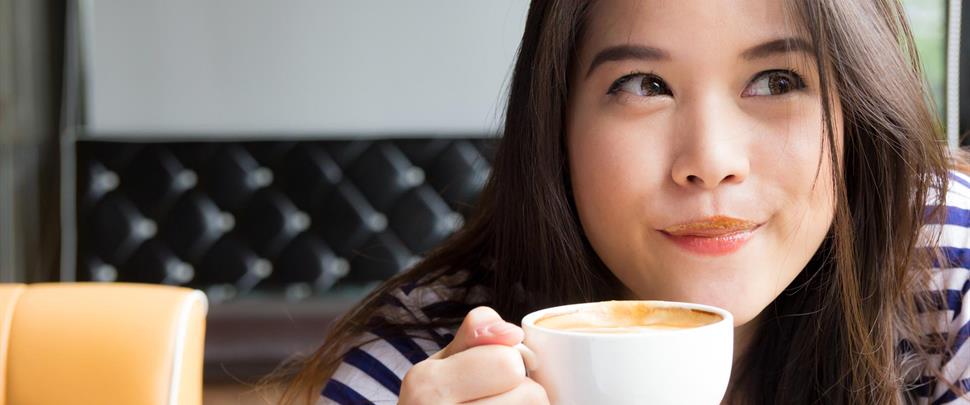 Asian-woman-smiling-and-drinking-coffee