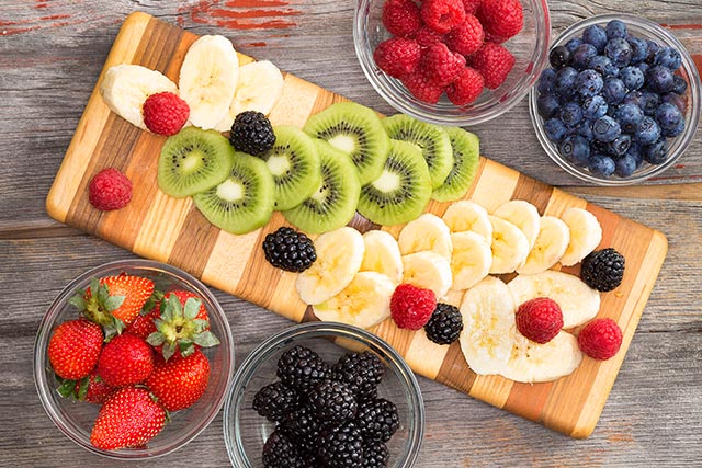 preparing-a-healthy-fruit-salad-with-mixed-berries